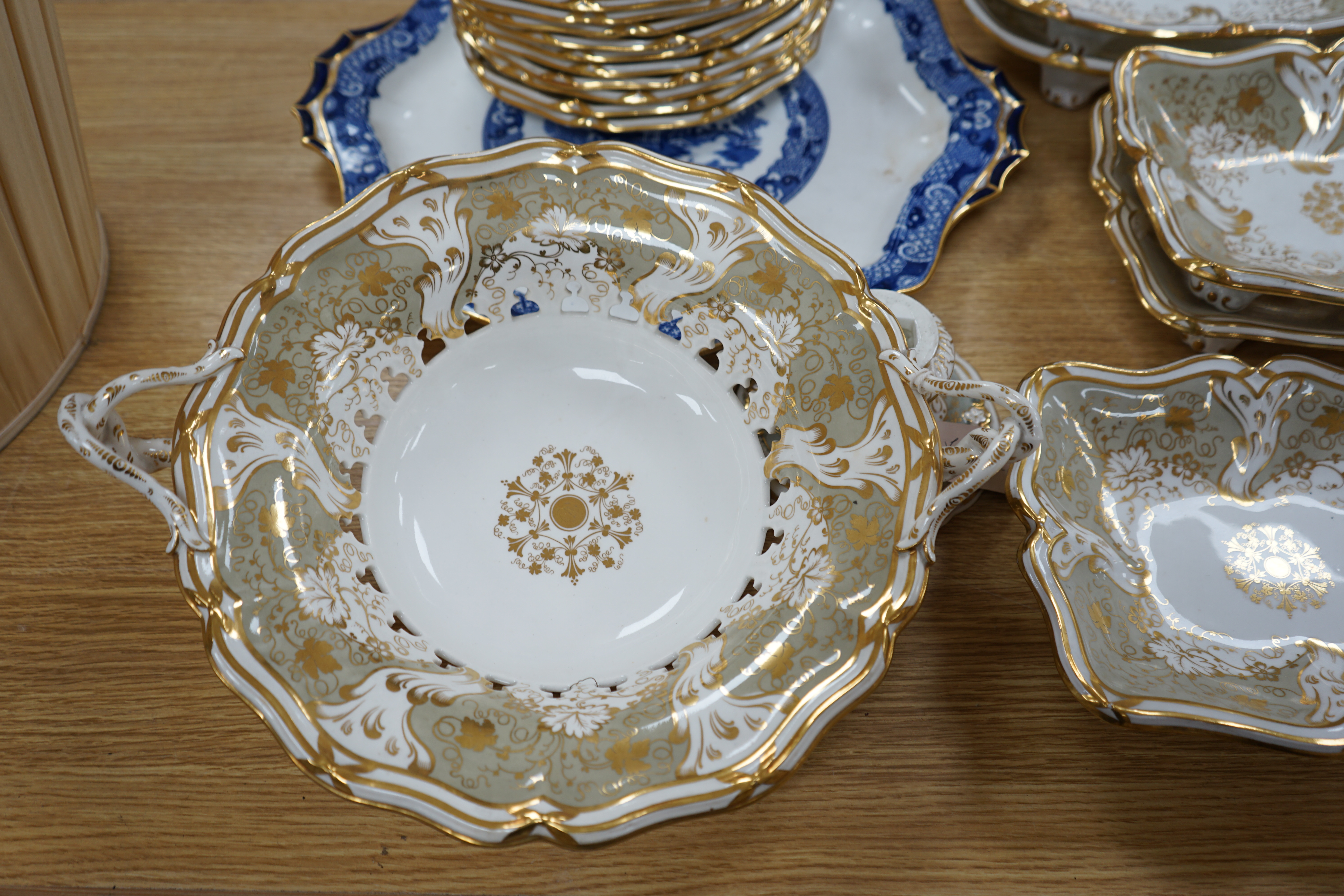 A Davenport part grey and gilt dessert service, together with a blue and white circular serving dish, dish 43cm wide. Condition - comport base broken